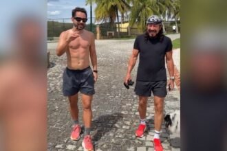 Everton Ribeiro e Bell Marques caminhando juntos em fazenda