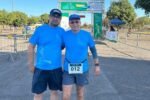 Pai e filho sorrindo juntos em evento de corrida