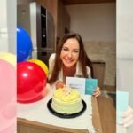 Mulher sopra velas de bolo de aniversário
